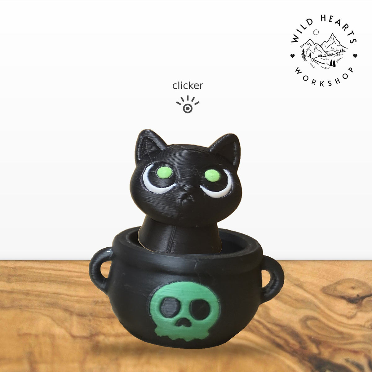 Black Cat clicker top (black cat with green eyes) seated in the black cauldron with green skull base