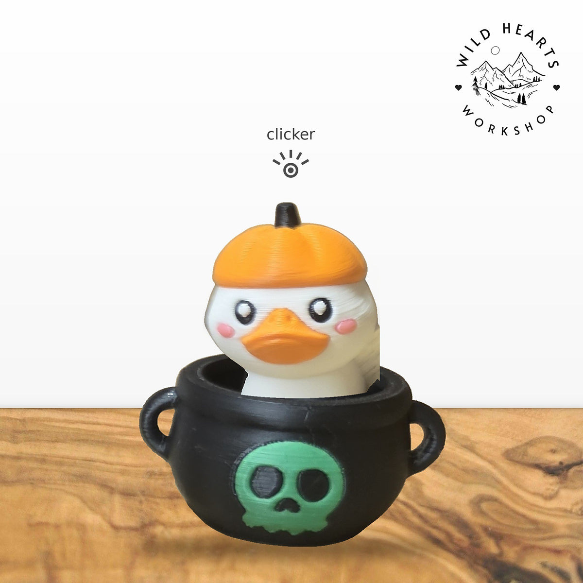 Pumpkin Duck clicker top (pumpkin-hat duck) seated in the black cauldron with green skull base