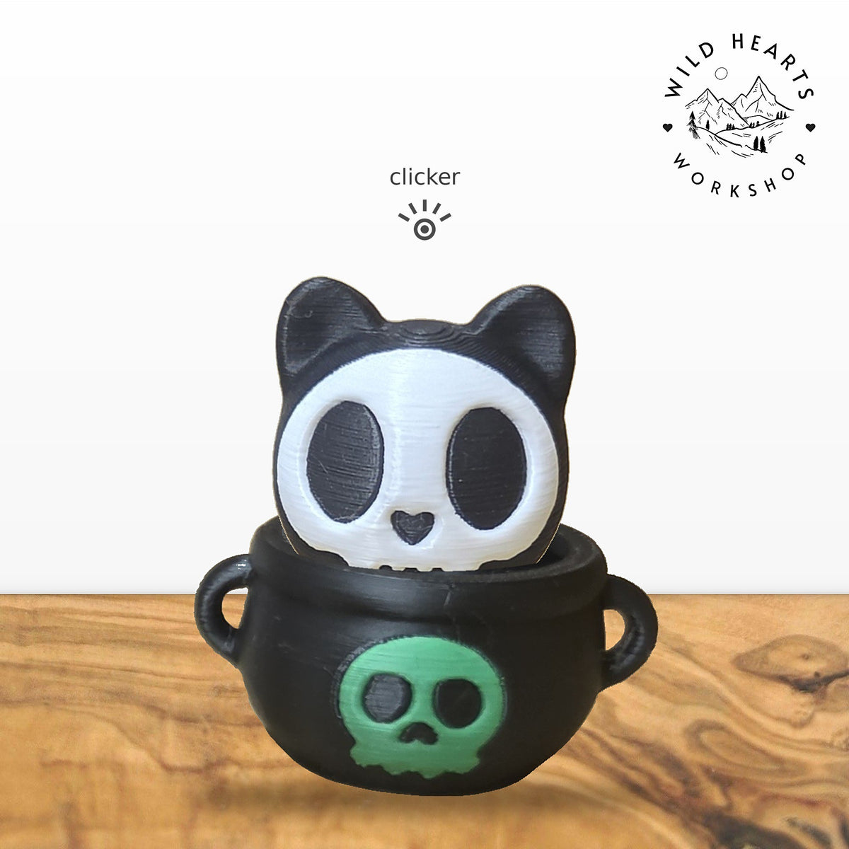 Skeleton Cat clicker top (skeleton cat) seated in the black cauldron with green skull base