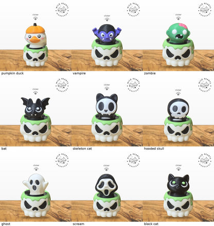 All 9 Halloween clicker tops shown in the white skull pot with green slime rim