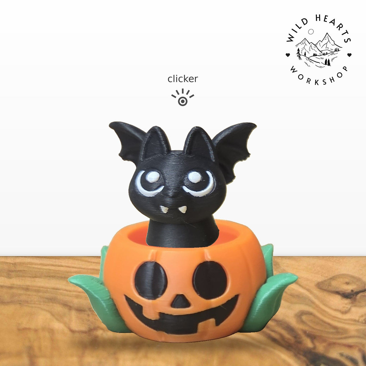 Bat clicker top (black bat) seated in the orange jack-o-lantern pot with green leaves base
