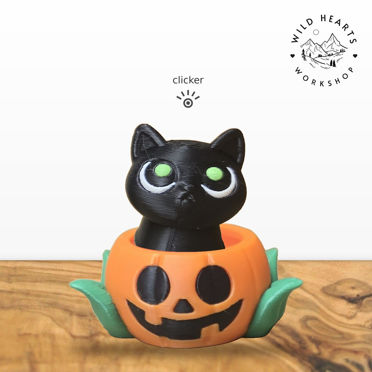 Black Cat clicker top (black cat with green eyes) seated in the orange jack-o-lantern pot with green leaves base