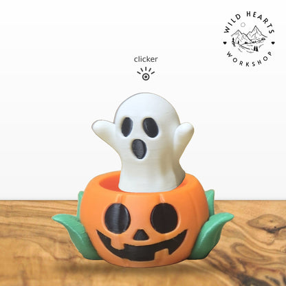 Ghost clicker top (white ghost) seated in the orange jack-o-lantern pot with green leaves base