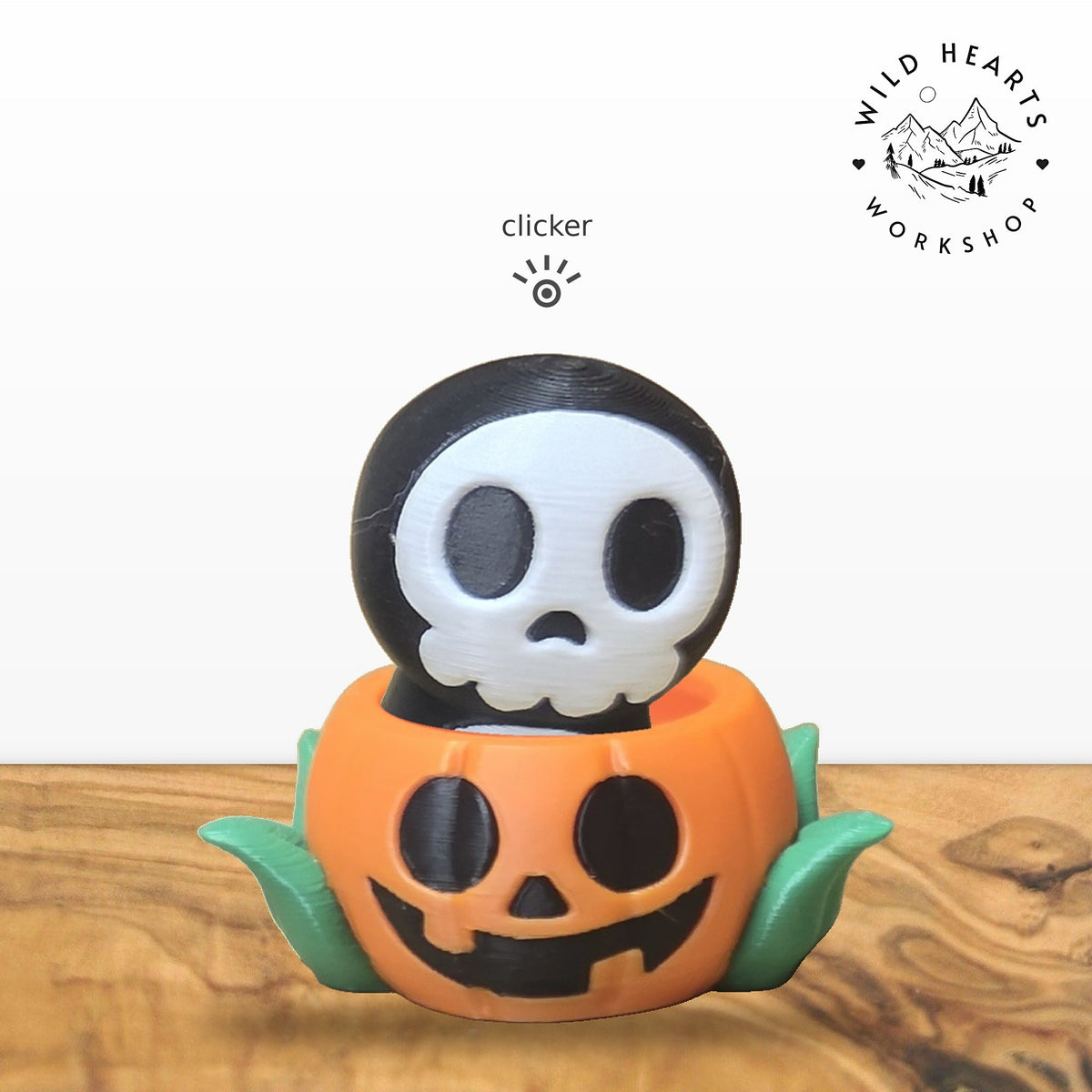 Hooded Skull clicker top (hooded skeleton skull) seated in the orange jack-o-lantern pot with green leaves base