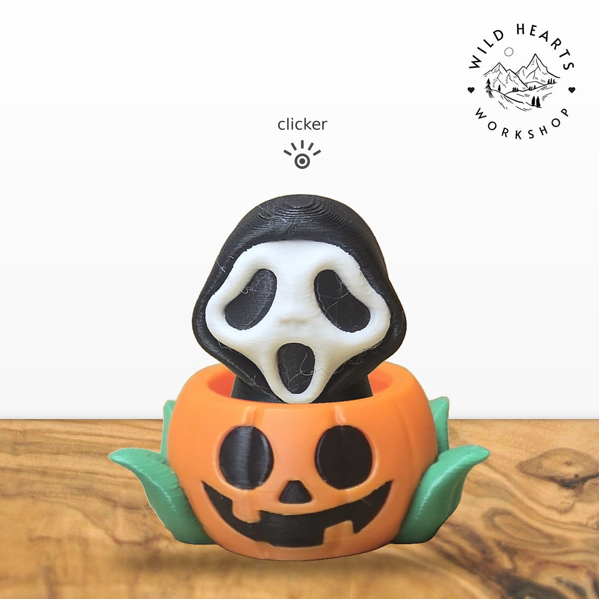 Scream Mask clicker top (Scream mask ghost) seated in the orange jack-o-lantern pot with green leaves base