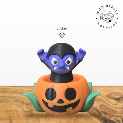 Vampire clicker top (purple vampire) seated in the orange jack-o-lantern pot with green leaves base