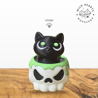 Black Cat clicker top (black cat with green eyes) seated in the white skull pot with green slime rim base