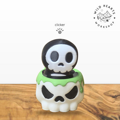 Hooded Skull clicker top (hooded skeleton skull) seated in the white skull pot with green slime rim base