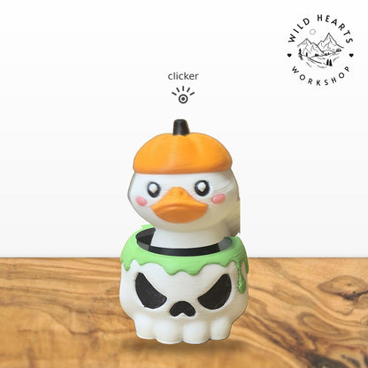 Pumpkin Duck clicker top (pumpkin-hat duck) seated in the white skull pot with green slime rim base