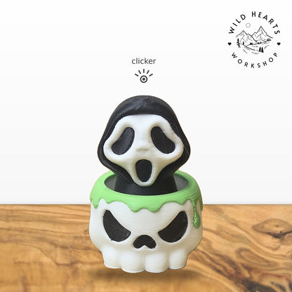 Scream Mask clicker top (Scream mask ghost) seated in the white skull pot with green slime rim base